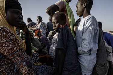 People in the back of a truck outside an IDP camp in Maidaguri. Women and children leave the safety of the camps on a daily basis, crossing the defensive trenches, to work in the fields as hired hands...