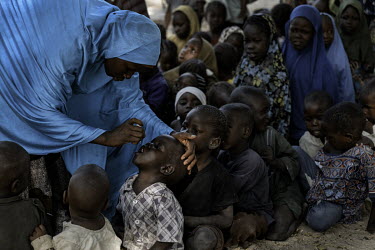 Children receiving oral polio vaccinations.