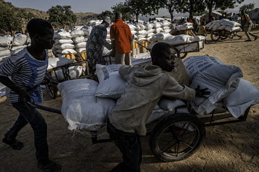 The monthly delivery of food from the World Food Programme (WFP). Food supplies have been disrupted by the COVID-19 pandemic and many displaced people living in unofficial settlements receive no aid.