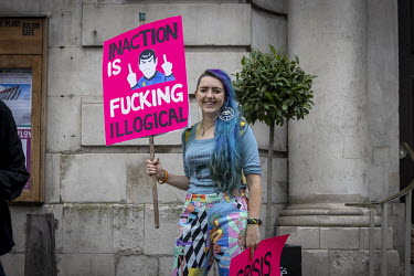 A woman holds a placard at the 'opening ceremony' of the 'August 2021 Rebellion', a funeral march with an 'earth coffin' to The Guildhall, home to the City of London Corpration. Extinction Rebellion a...