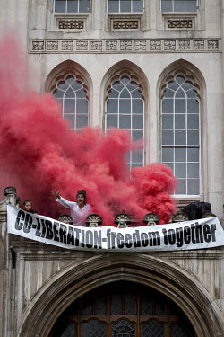 Red smoke rises from a balcony at The Guildhall, home to the City of London Corporation, during the 'August 2021 Rebellion'. Extinction Rebellion activists scaled the front of the building and hung ba...