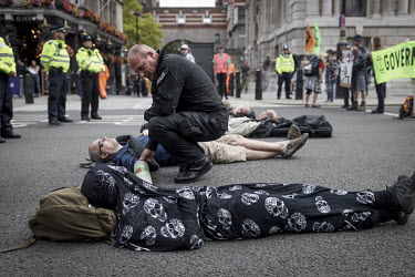 Extinction Rebellion (XR) activists lie down to occupy and block Whitehall.