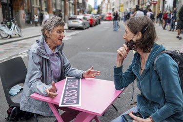 An Extinction Rebellion activist talks with public at a 'Crisis Table' during a march and occupation in London's West End.