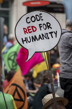 'Code red for humanity', a sign displayed during an Extinction Rebellion 'Stop the Harm' march from Hyde Park to the Department for Business, Energy and Industrial Strategy.