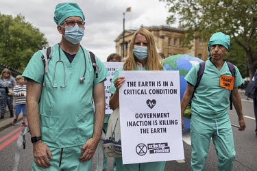 People dressed in medic's scrubs during an XR 'Stop the Harm' march from Hyde Park to the Department for Business, Energy and Industrial Strategy.