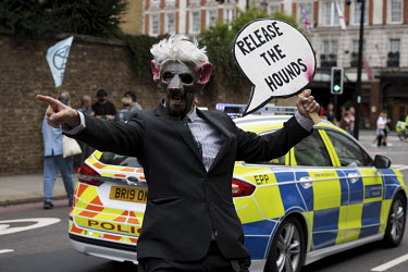 An Extinction Rebellion activist from the 'Corp Rats' during the 'Stop the Harm' march from Hyde Park to the Department for Business, Energy and Industrial Strategy.