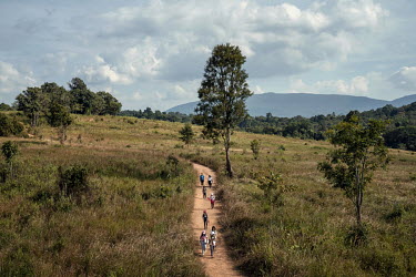 Visitors walk along a trail in Khao Yai National Park.