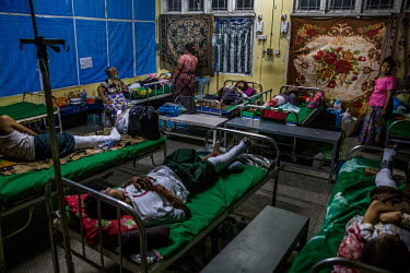Patients and family members in a makeshift hospital ward where volunteer medical workers have been discreetly treating people brought in with gunshot wounds and other injuries as the security forces h...