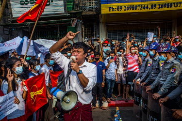 A man on a megaphone and protestors try to encourage police to join the people as thousands gather to demonstrate against the coup and show their support for the National League for Democracy ( NLD )...