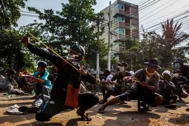 During a clash, protestors use homemade weapons such as airguns and slingshots to beat back police and army forces from coming into their neighborhood of Tharketa township. On 2 February 2021 the Mayn...