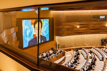 Qu Dongyu, Chinese Director General of the Food and Agriculture Organisation of the United Nations (FAO), is seen on a large screen, speaking at the Afghanistan UN Conference.