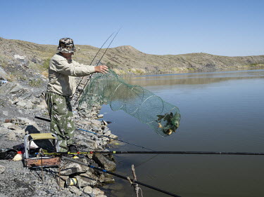 Local residents fish in Lake Chagan or 'Atomic Lake', a crater lake 100m deep and 400m wide that was created after an underground test with an atomic bomb in 1965. The lake shore is still radioactivel...