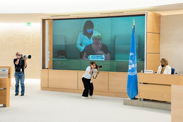 Members of the press and the UN photographing the United Nations High Commissioner for Human Rights Michelle Bachelet addressing the opening session of the UN Human Rights Council deliberations in Gen...