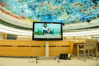 United Nations High Commissioner for Human Rights Michelle Bachelet addressing the opening session of the UN Human Rights Council deliberations in Geneva, seen on a screen in the room. Due to Covid re...