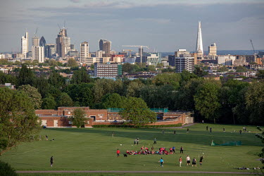 Sports activities taking place on Hampstead Heath with the City of London seen in the background.