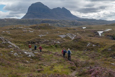 North-West Scottish Highlands with a group of walkers enroute to climb Suilven, the mountain seen in the distance