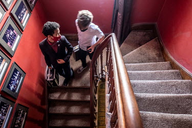 Magic students walk downstairs after class at the Cape Town College of Magic, which is housed in a historic building in the Claremont neighbourhood of the city.