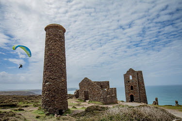 Hang-glider above the ruins of a coastal tin mine. The mines have been sealed off for many years and have only served as a tourist attraction for a glimpse of Cornwall's architectural heritage and ind...