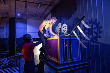 Performers from the Cape Town College of Magic make last minute adjustments to a piece of equipment backstage before a magic show at the Artscape Theatre.