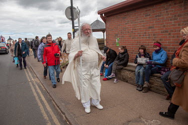A man with a long white beard, dressed as Gandalf from Lord of the Rings walks down the street. Goths, Victorian-era dressers, Steam-Punks and others flock to the town on the Yorkshire coast which is...