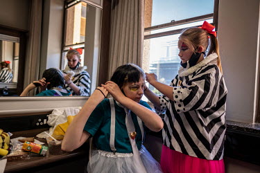 Students of the Cape Town College of Magic Emilie Van Den Hooyen and Maelle Oudejans help each other get ready for a performance at the Artscape Theatre.