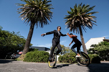 Students practice using unicycles at the Cape Town College of Magic.