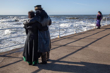 Participants in the semi annual 'Goth Weekend' look out to the North Sea. Goths, Victorian era dressers, 'Steam Punks and others flock to the town on the Yorkshire coast which is the setting in Bram S...