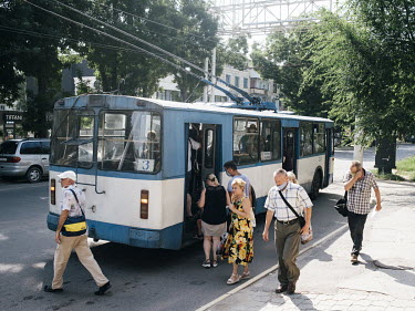 People board a trolleybus in Tiraspol.