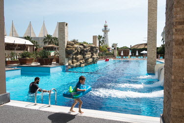 A father and son play in the men only section of the Adenya Hotel and Resort swimming pool. Halal hotels have sex segregated swimming pools, beaches, and spa facilities.
