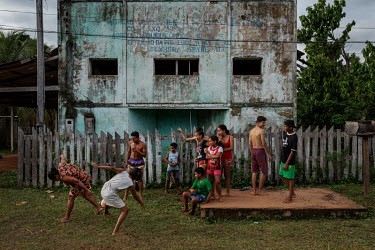 People from the quilombola (founded by escaped slaves) community of Forte Principe da Beira in Rondonia watch a local football match in front of the former offices of the community association.