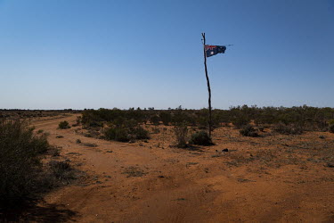 A ragged Australian flag at the entrance to a property near Menindee Lakes. The Menindee Lakes have experienced years of drought and were completely dry until 2021.