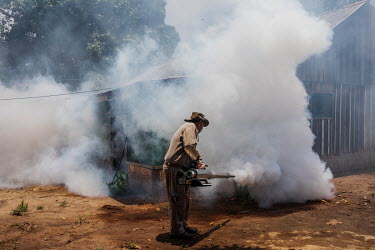 An employee of the National Health Foundation of Brazil (FUNASA) uses smoke against a type of mosquito that spreads malaria in a house in the quilombola (founded by escaped slaves) community of Forte...