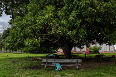 A drunken resident is slumped on a bench in the quilombola (founded by escaped slaves) community of Pedras Negras in Rondonia.