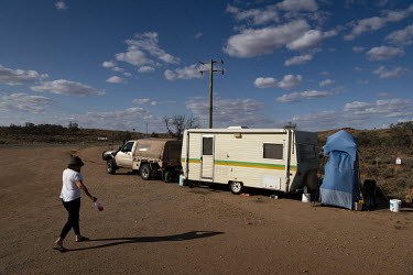 Teresa Young walks towards her caravan to refill her water bottle. Teresa, 75, and husband Thomas Young, 76 from Wallaroo in South Australia are stuck on the NSW side of the New South Wales - South Au...