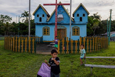 Children play in front of the Brotherhood of the Holy Cross Church, a religious movement founded by Jose Francisco da Cruz in the 1970s, in the village of Sao Pedro do Norte on the banks of the Javari...