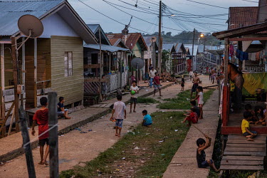 Children play on a street that runs past wooden shacks in the Vale do Javari indigenous territory.