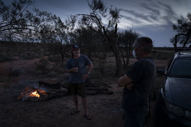 Darryl Hazell talks with fellow stranded traveller Thomas Young at his camp next to the highway. Darryl Hazell from Adelaide, South Australia, travelled a week earlier to Queensland from his home in S...