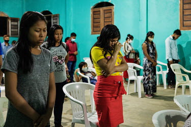 Indigenous people take part in a service in the Presbyterian Church of Brazil in a village in the Vale do Javari indigenous territory.