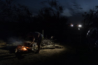 Darryl Hazell, 66, from Adelaide in South Australia lights a fire next to his car. He was en route from Queensland to his home when he got stuck in New South Wales as state borders were closed due to...