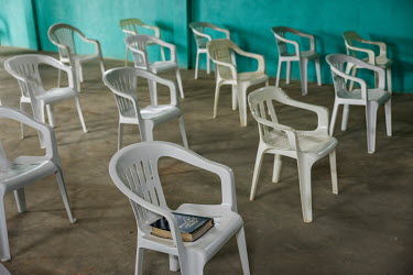 Plastic chairs, one with a bible resting on it, in the church hall run by the Presbyterian Church of Brazil in a village in the Vale do Javari indigenous territory.