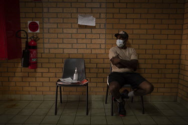 Anthony Elwood, 24, a young Aboriginal farm worker, waits for his first vaccination shot.