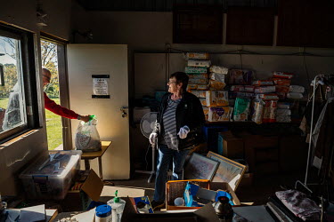 Liz Martin, a volunteer at the Cobargo Relief Centre, sorts through donated items for residents who have been affected by the bushfires. During the coronavirus lockdown the volunteers must pass out an...