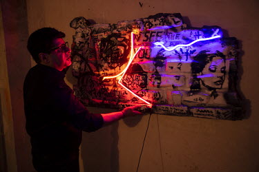 Artist Ali Breyte at his home in the Azodi district. He is known for his mixed media art that often features neon tubes.