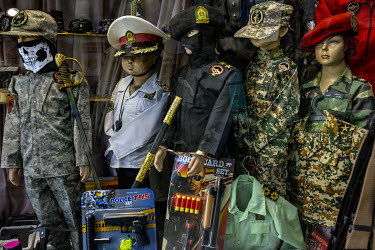 Children's uniforms and toy guns for sale in a shop selling millitary clothing for the public and also members of the Revolutionary Guards.