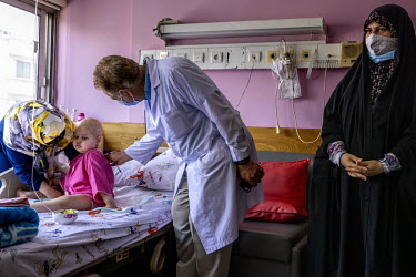 Dr Mardani examines Reyanei (5), who has leukemia, at the Merh Hospital. Due to sanctions many patients cannot find the drugs they need and if they can they are very expensive or not the the exact med...