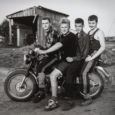 Four men on a motorbike in Marfino, a village outside of Moscow.From the series 'Russian Portraits', photos and interviews with ordinary Russians as their country stood at an ideological crossroads du...