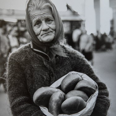 Valentina, selling bread on the street in Moscow. A military widow, her husband was a former officer in the Soviet border army in Uzbekistan. When it gained independence from the Soviet Union, Valenti...