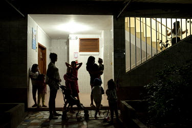 Women and their children living at the centre for women who have experienced domestic violence prepare to head up to their bedrooms for the night.