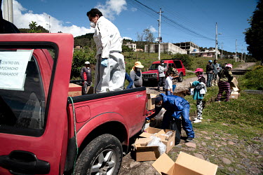 People distribute parcels intended for poor families struggling during the covid pandmic in northern Quito.