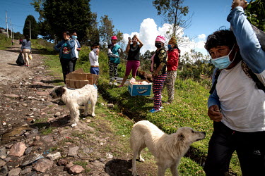 Families receive 'solidarity kits', boxes with good for those struggling during the covid pandemic, on the outskirts of Quito.